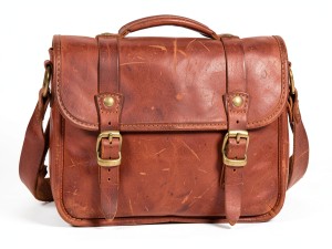 Vintage leather satchel bag with brass buckles and stitching details