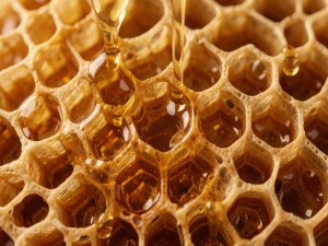 Hyper-realistic macro shot of honeycomb structure with golden liquid dripping